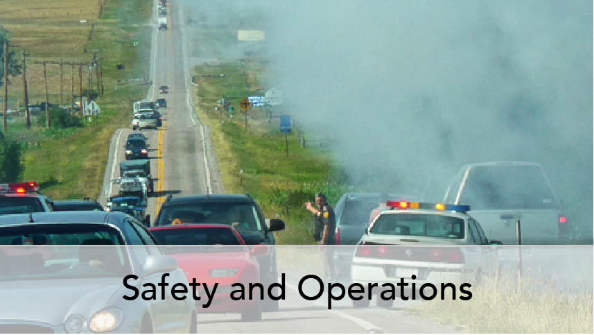 WTI Program Thumb Safety and Operations. Image of vehicles backed up on rural road at site of crash. Enforcement vehicle and traffic management.