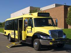 Streamline bus with front mounted bike rack and wheelchair loading ramp deployed.