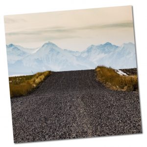 Gravel road in rural Montana with mountains in the background
