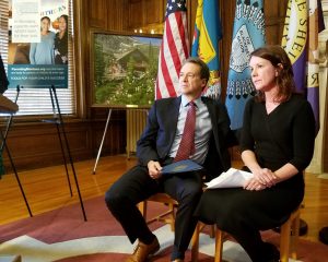 Photo of Montana Governor Steve Bullock and Annmarie McMahill seated at a news conference