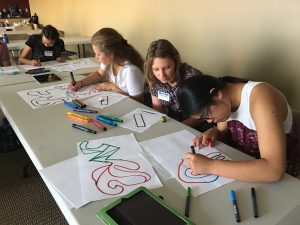 four students participate in design activity at 2018 summer camp