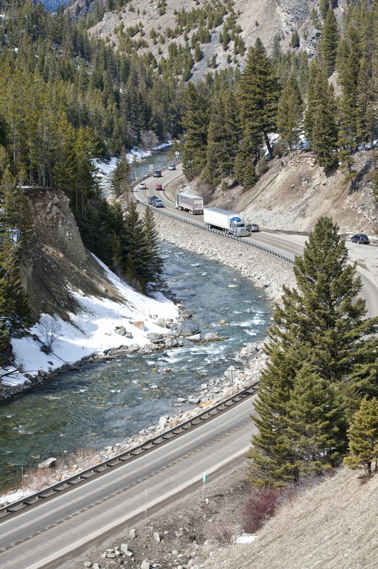 Semi trucks and vehicles, navigate the curves of Hwy 191 along the Gallatin river.