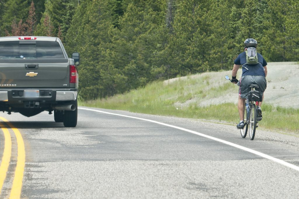 Truck passing a bicyclist on a rural highway
